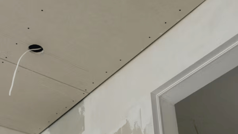 Interior ceiling drywall repair in progress after a roof leak caused water damage and staining.